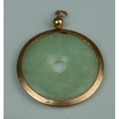 159 - A CHINESE JADE BI SET IN 9CT GOLD, 

In Goldsmiths and Silversmiths Company case. 

Weight: 8.55gms ... 