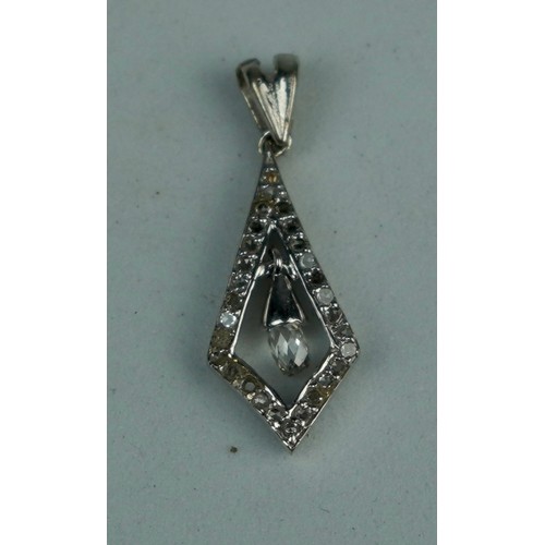 223 - A BRIOLETTE CUT DIAMOND IN PENDANT SET WITH SMALL DIAMONDS,

Weight: 1.2gms 

Pendant 19mm x 10mm