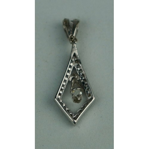 223 - A BRIOLETTE CUT DIAMOND IN PENDANT SET WITH SMALL DIAMONDS,

Weight: 1.2gms 

Pendant 19mm x 10mm