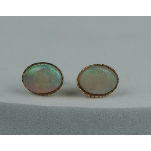 221 - A PAIR OF OPAL EARRINGS SET IN 9CT GOLD, 

Total weight: 0.72gms

10mm x 0.6mm each.