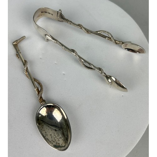 131A - A SET OF LATE 19TH SILVER CENTURY TEASPOONS IN THE FORM OF RIDING CROPS ALONG WITH A PAIR OF TONGS B... 