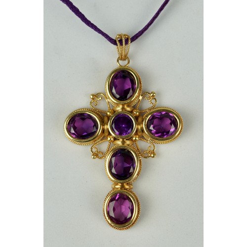 173 - AN 18CT GOLD CROSS SET WITH SIX AMETHYSTS,

Weight 31.8gms 

6cm x 4.5cm