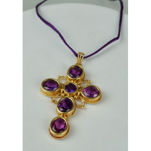 173 - AN 18CT GOLD CROSS SET WITH SIX AMETHYSTS,

Weight 31.8gms 

6cm x 4.5cm