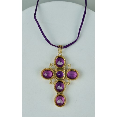 173 - AN 18CT GOLD CROSS SET WITH SIX AMETHYSTS,

Weight 31.8gms 

6cm x 4.5cm