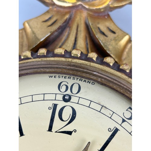 345 - A WESTERSTRAND GILTWOOD CLOCK WITH KEY,

In working condition. 

54cm x 30cm