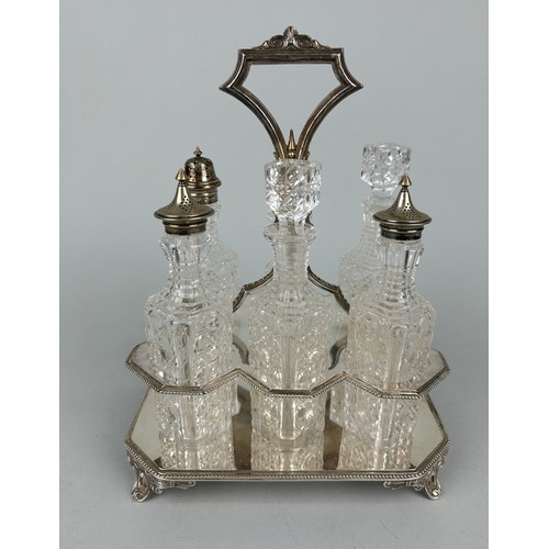 544 - A CUT GLASS CRUET SET WITH SILVER PLATED TOPS AND STAND,