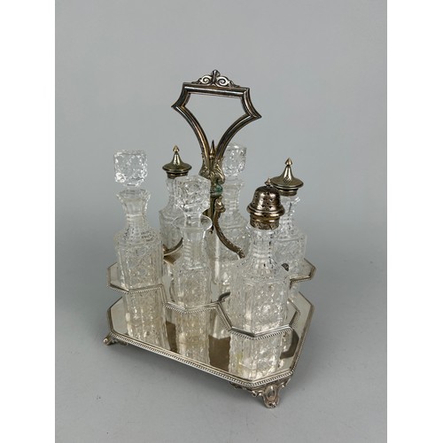 544 - A CUT GLASS CRUET SET WITH SILVER PLATED TOPS AND STAND,