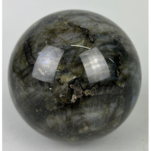 249A - A LABRADORITE SPHERE WITH STRIKING FLASHES OF GREEN AND BLUE,

11cm in diameter