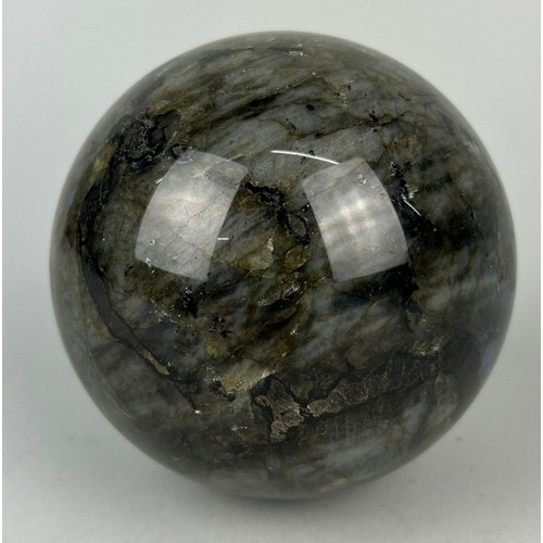 249A - A LABRADORITE SPHERE WITH STRIKING FLASHES OF GREEN AND BLUE,

11cm in diameter