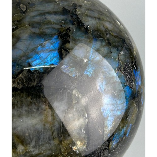 249A - A LABRADORITE SPHERE WITH STRIKING FLASHES OF GREEN AND BLUE,

11cm in diameter