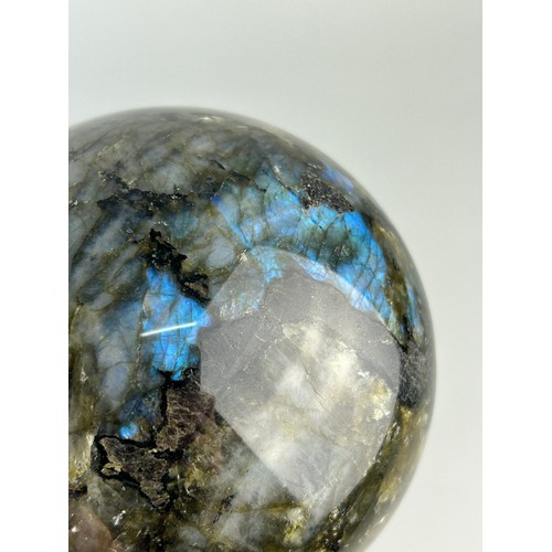 249A - A LABRADORITE SPHERE WITH STRIKING FLASHES OF GREEN AND BLUE,

11cm in diameter