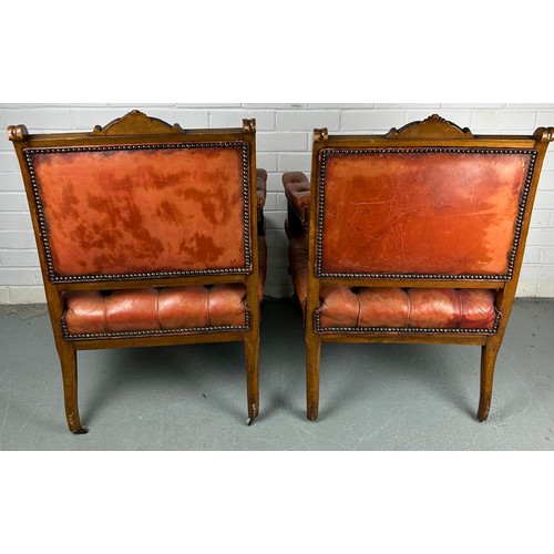 491 - A PAIR OF 19TH CENTURY BUTTON BACK FAUTEUILS, 

Each upholstered in red or tan leather, raised on fo... 