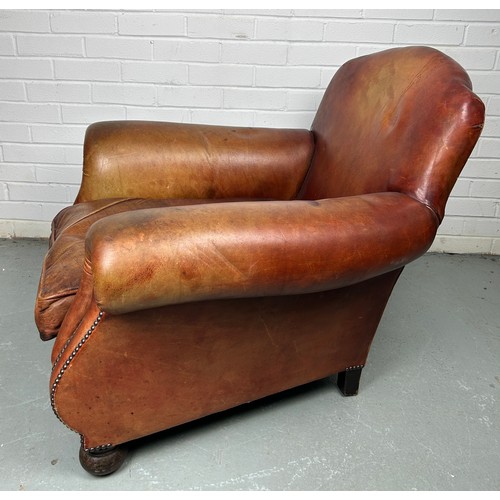 497 - A LARGE ART DECO TAN LEATHER CLUB CHAIR, 

85cm x 75cm x 75cm