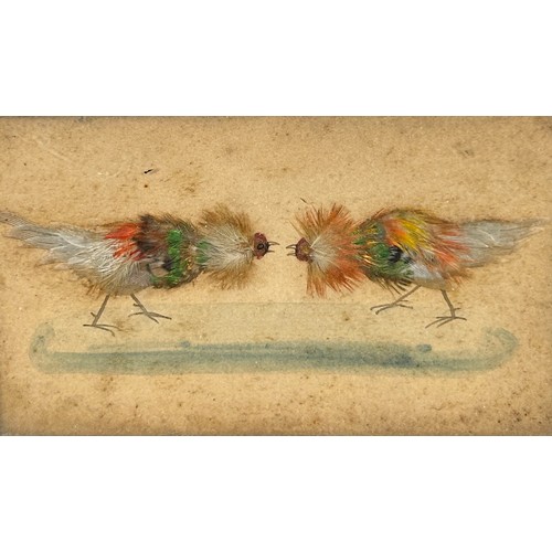 442 - COCKFIGHTING INTEREST: A FRAMED SET OF THREE WATERCOLOURS WITH APPLIED BIRD FEATHERS DEPICTING A COC... 