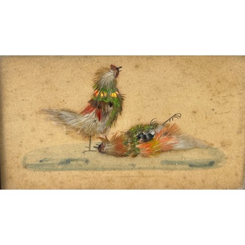 442 - COCKFIGHTING INTEREST: A FRAMED SET OF THREE WATERCOLOURS WITH APPLIED BIRD FEATHERS DEPICTING A COC... 