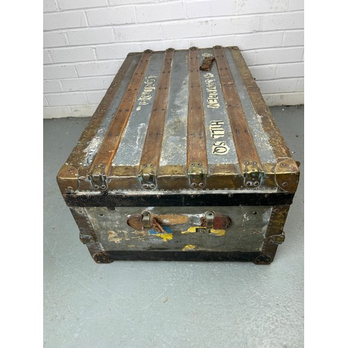 493 - A LARGE ZINC AND BRASS BOUND EXPLORERS TRUNK, 

92cm x 52cm x 33cm

Late 19th or early 20th Century,... 