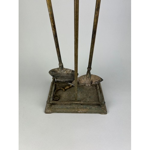 519 - A BRASS FIRE STAND AND TOOLS, 

70cm x 24cm