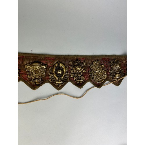 394 - A TIBETAN BELT WITH BRASS SYMBOLS,

71cm x 12cm