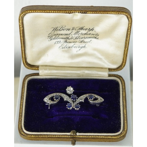 165 - A BELLE EPOCH OR 1920'S PLATINUM BROOCH SET WITH A CENTRAL DIAMOND, FIVE SAPPHIRES AND SMALLER DIAMO... 