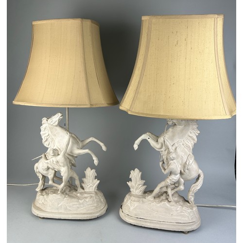 478 - EQUESTRIAN INTEREST: A PAIR OF WHITE PAINTED METAL LAMPS IN THE FORM OF A REARING HORSE AND TRAINER ... 