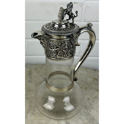 133A - A LARGE SILVER MOUNTED CLARET JUG WITH ENGRAVING '1ST PRIZE 1902 LEAMINGTON E.ALLCOCK LE MELLOR', 

... 