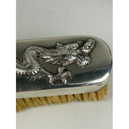 131 - A SILVER CHINESE EXPORT BRUSH WITH REPOUSSE FOUR CLAWED DRAGON, 

16cm L