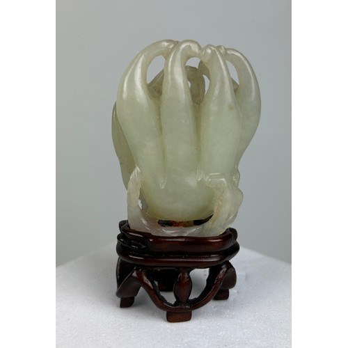 33 - A 19TH CENTURY CHINESE WHITE JADE CARVING OF A BUDDHAS HAND CITRON, 

5cm x 3.8cm 

On later rosewoo... 