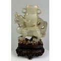 AN 18TH CENTURY CHINESE JADE WINGED DRAGON CARRYING AN ARCHAIC VASE, 7.5cm x 6.3cm x 2cm 

Provenanc... 