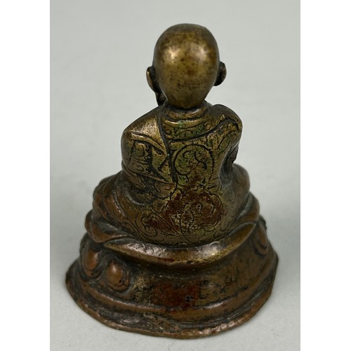 17 - A 19TH CENTURY BRONZE FIGURE OF A SEATED MONK,

7cm x 5cm