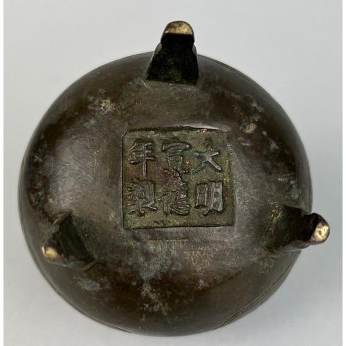 6 - A CHINESE BRONZE CENSER ON TRIPOD FEET WITH SIX CHARACTER MARK TO VERSO, 

9cm x 9cm