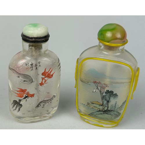 108 - TWO GLASS SNUFF BOTTLES DECORATED WITH FISH AND LANDSCAPE SCENES,

Each 7cm H