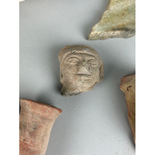 246 - A COLLECTION OF ANCIENT COLLECTION OF POTTERY FRAGMENTS ALONG WITH A CARVED LIMESTONE BUST OF A MANS... 