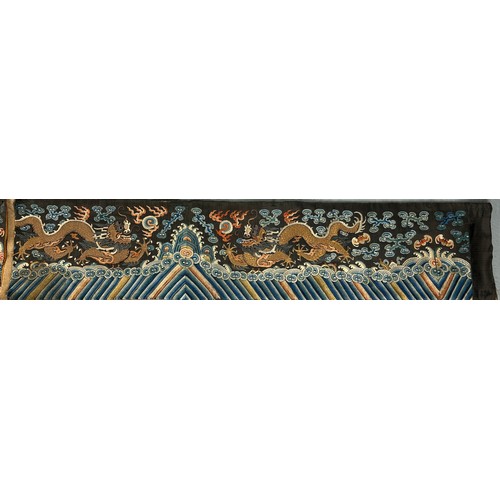 93 - A LARGE CHINESE SILK BANNER DECORATED WITH A FIVE CLAW DRAGON CHASING THE FLAMING PEARL, 

215cm x 2... 