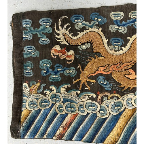 93 - A LARGE CHINESE SILK BANNER DECORATED WITH A FIVE CLAW DRAGON CHASING THE FLAMING PEARL, 

215cm x 2... 