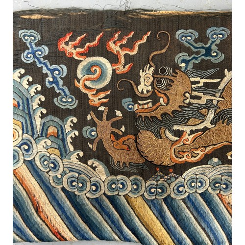 93 - A LARGE CHINESE SILK BANNER DECORATED WITH A FIVE CLAW DRAGON CHASING THE FLAMING PEARL, 

215cm x 2... 