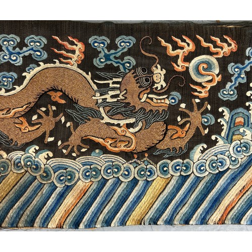 93 - A LARGE CHINESE SILK BANNER DECORATED WITH A FIVE CLAW DRAGON CHASING THE FLAMING PEARL, 

215cm x 2... 