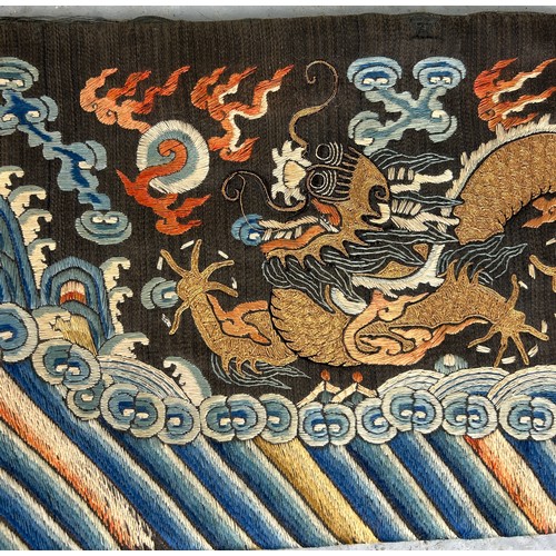 93 - A LARGE CHINESE SILK BANNER DECORATED WITH A FIVE CLAW DRAGON CHASING THE FLAMING PEARL, 

215cm x 2... 