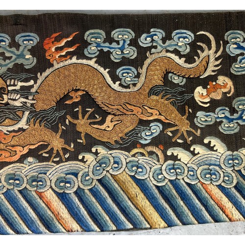 93 - A LARGE CHINESE SILK BANNER DECORATED WITH A FIVE CLAW DRAGON CHASING THE FLAMING PEARL, 

215cm x 2... 