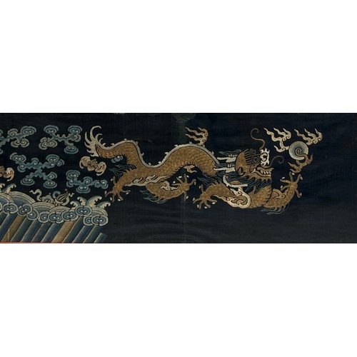 94 - A 19TH CENTURY CHINESE EMBROIDERED SILK PANEL DEPICTING A FIVE CLAWED DRAGON CHASING THE FLAMING PEA... 