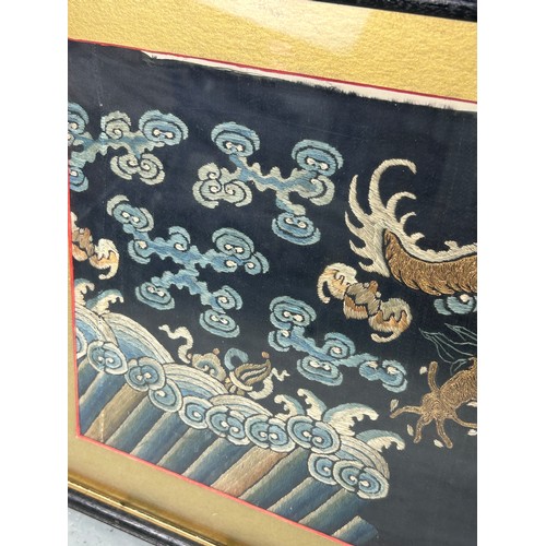 94 - A 19TH CENTURY CHINESE EMBROIDERED SILK PANEL DEPICTING A FIVE CLAWED DRAGON CHASING THE FLAMING PEA... 