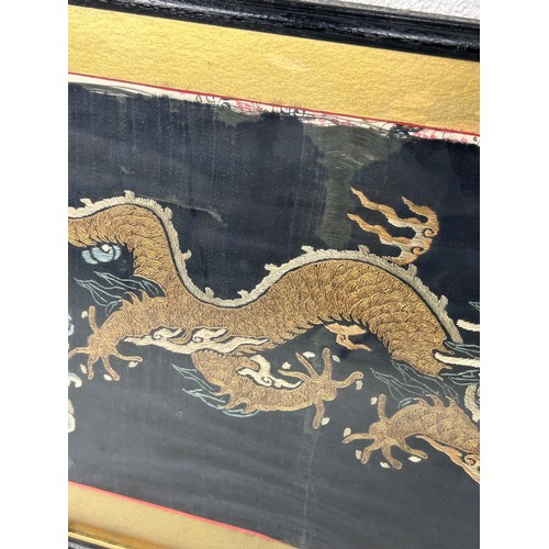 94 - A 19TH CENTURY CHINESE EMBROIDERED SILK PANEL DEPICTING A FIVE CLAWED DRAGON CHASING THE FLAMING PEA... 