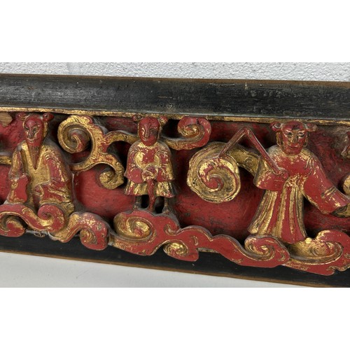 99A - A CHINESE RED LACQUER AND GILT CARVED WOOD PANEL DEPICTING FIGURES,

67cm x 14cm