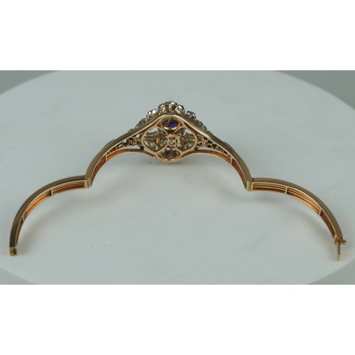 160 - A FINE 14CT GOLD BANGLE WITH CENTRAL CLAW SET SAPPHIRE SURROUNDED BY DIAMOND CLUSTERS,

Multi functi... 