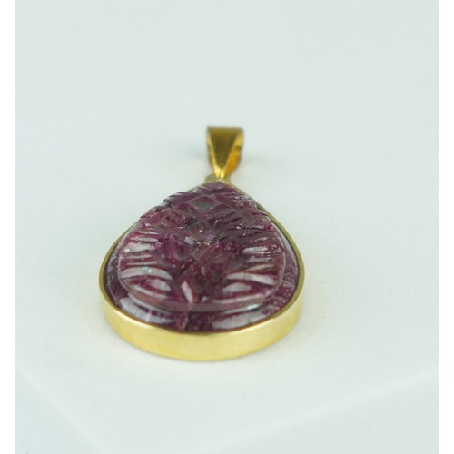 224 - A CARVED RUBY OF TEARDROP FORM MOUNTED IN YELLOW METAL PENDANT, 

6.1gms

Stone 28mm x 19mm