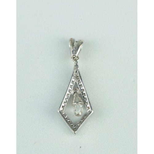 223 - A BRIOLETTE CUT DIAMOND IN PENDANT SET WITH SMALL DIAMONDS,

Weight: 1.2gms 

Pendant 19mm x 10mm