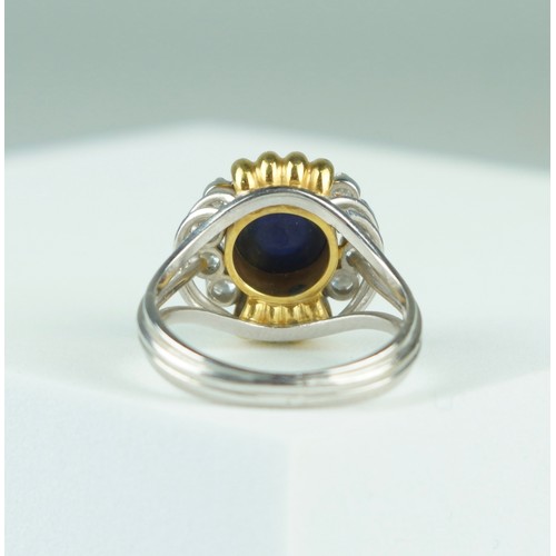 179 - AN 18CT GOLD RING SET WITH A SAPPHIRE AND EIGHT DIAMONDS  8.9gms