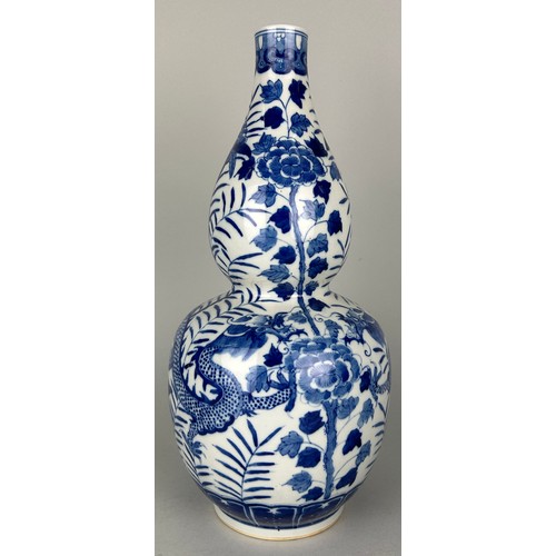 114C - A CHINESE BLUE AND WHITE DOUBLE GOURD VASE DECORATED WITH A DRAGON, 

36cm H