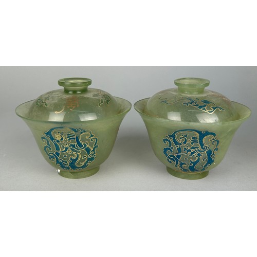 114H - A PAIR OF JADE TEA CUPS AND COVERS,

10cm x 6cm each.