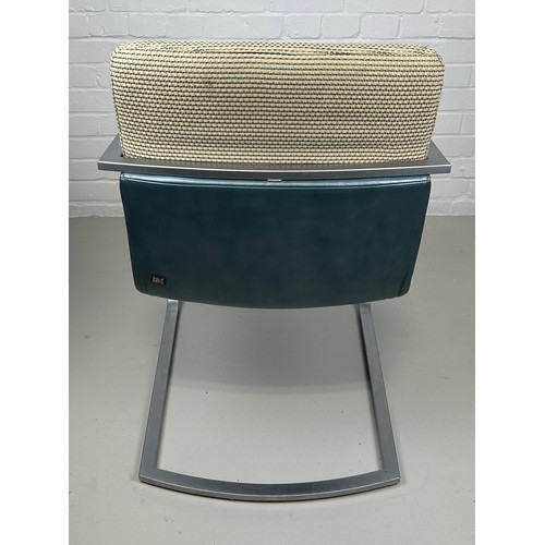 463 - A ROLF BENZ ARMCHAIR, 

Chrome frame and blue leather seat with cream upholstered back cushion.

85c... 