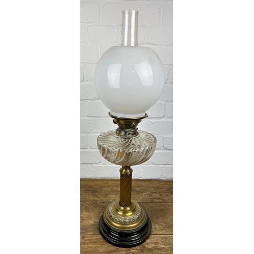 524 - A BRASS OIL LAMP WITH GLASS SHADE,